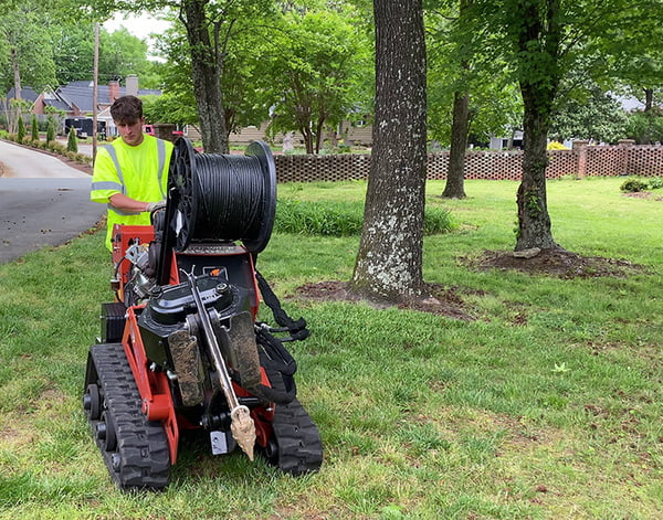 A Drop Bury Technician gets set up to plow fiber on a job.